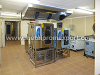 A food preparation facility including installed industrial equipment in the modular hostel with the cafeteria